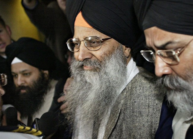 Ripudaman Singh Malik (centre) leaves B.C. Supreme Court in Vancouver, B.C. on March 16, 2005. Vancouver South Liberal candidate Ujjal Dosanjh has lodged a complaint with Elections Canada after the man acquitted of the Air India terror bombings endorsed his Conservative rival. THE CANADIAN PRESS/ Richard Lam.