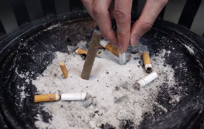 A man puts out a cigarette.