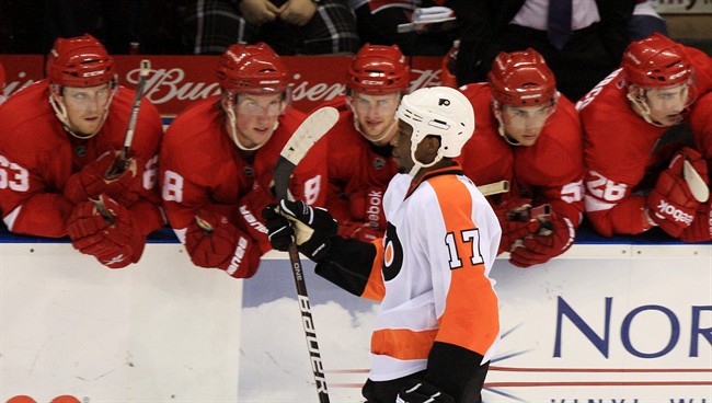 Philadelphia Flyers' Wayne Simmonds heads back to the bench after scoring on Detroit Red Wings goalie Jordan Pearce during the shoot out of pre-season NHL hockey action in London, Ontario, Thursday, September 22, 2011. THE CANADIAN PRESS/Dave Chidley.