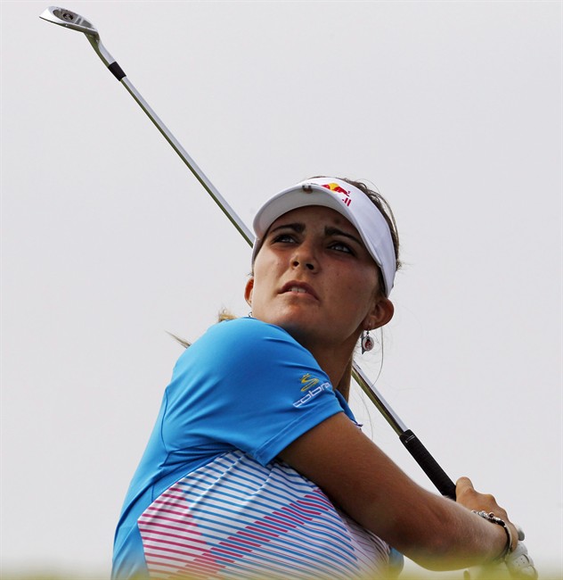 FILE - In this Sept. 18, 2011, file photo, Lexi Thompson watches her approach shot to the third hole during the final round of the Navistar LPGA Classic golf tournament at Capitol Hill at the Robert Trent Jones Golf Trail in Prattville, Ala. Thompson will be going to work full-time on the LPGA Tour next year. The 16-year-old Thompson asked the LPGA to waive its requirement that members be at least 18 to join. LPGA commissioner Mike Whan approved the petition on Friday, one day after Thompson filed it. (AP Photo/Dave Martin, File).