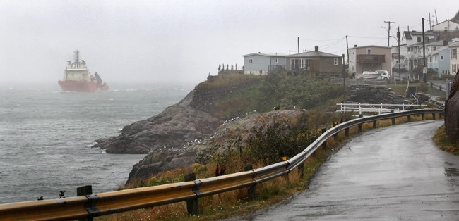 The offshore supply vessel Atlantic Osprey enters the St. John's Narrows in the fog and rain generated by post-tropical storm Maria. THE CANADIAN PRESS/Paul Daly.