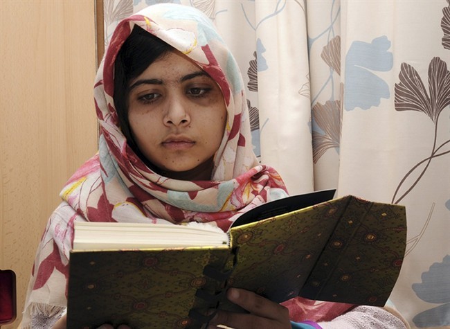 FILE - In this undated file photo provided by Queen Elizabeth Hospital in Birmingham, England, Malala Yousufzai reads a book.
