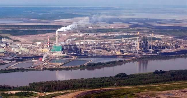 A Suncor mine facility along the Athabasca river as seen from a helicopter tour of the oil sands near Fort McMurray, Alta., Tuesday, July 10, 2012.