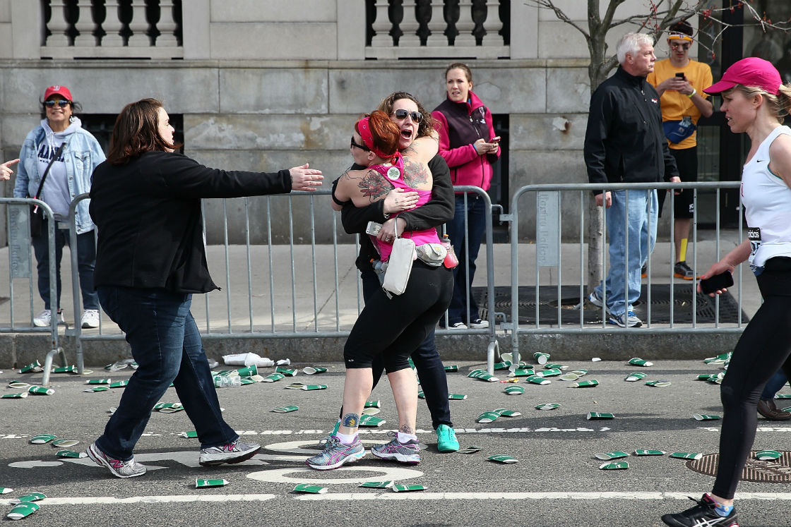 A runner embraces another woman on the marathon route near Kenmore Square after two bombs exploded during the 117th Boston Marathon on April 15, 2013 in Boston, Massachusetts. 