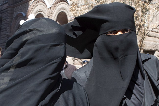 Unidentified women wear niqabs outside an Ontario court house in Toronto on Tuesday April 23, 2013.