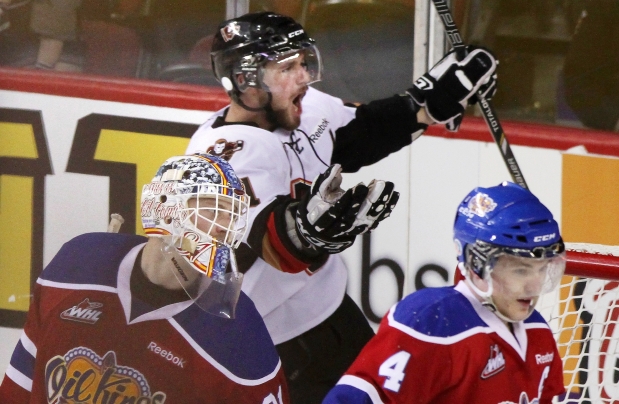 Brooks Macek of the Calgary Hitmen celebrates after scoring the winning goal in overtime against the Edmonton Oil Kings in the sixth game of the Western Hockey League’s Eastern Conference final on Sunday at the Scotiabank Saddledome.