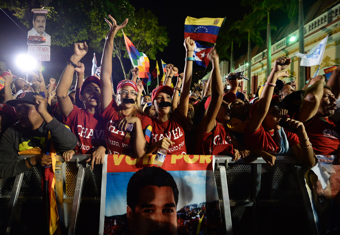 Supporters of Venezuelan acting President Nicolas Maduro celebrate after knowing the election results in Caracas on April 14, 2013. 