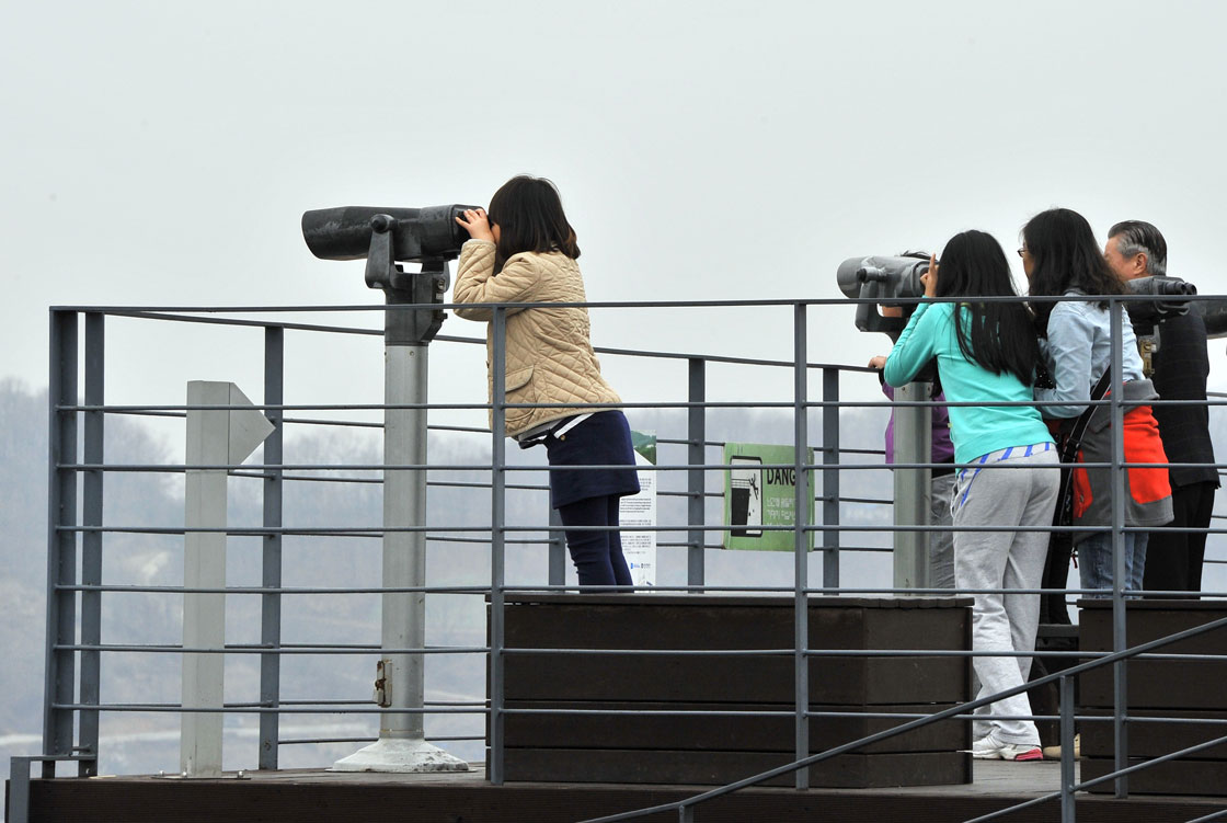 Visitors look toward the north side at Imjingak peace park near the demilitarized zone dividing the two Koreas in the border city of Paju on April 5, 2013.