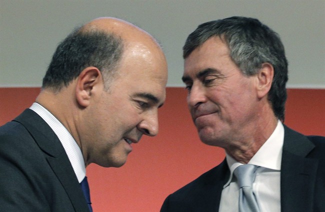 FILE - In this Sept. 28, 2012 file photo, France's Finance Minister Pierre Moscovici, left, and then Budget Minister Jerome Cahuzac attend a press conference in Paris. Francois Hollande is a President on the ropes, reeling from a potentially knockout blow delivered by his ex-budget minister, a man who admitted this week that he had hidden hundreds of thousands of euros from the taxman for decades and lied about it. Those lies from Jerome Cahuzac came both in front of the National Assembly and to Hollande's own face.