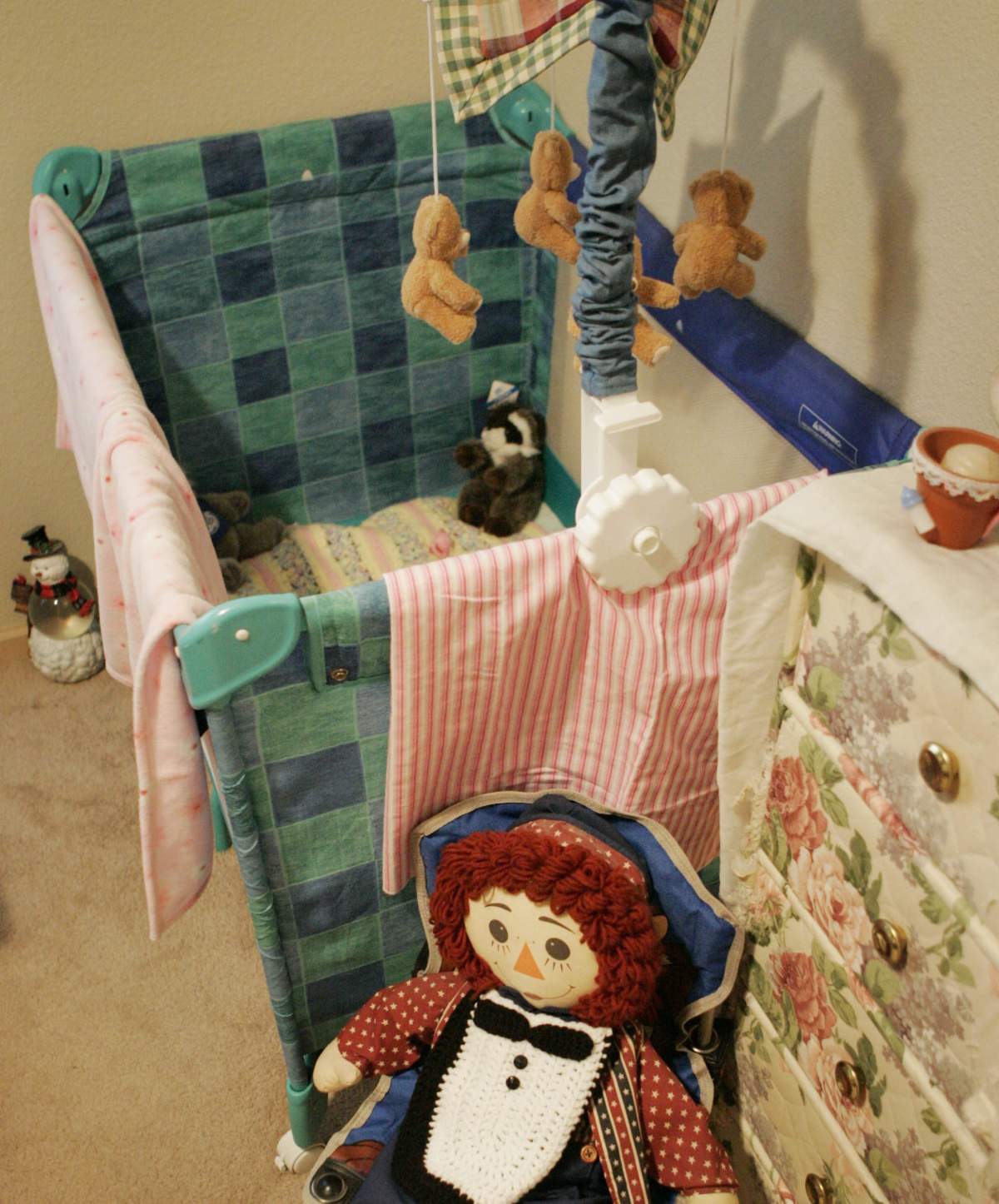 A playpen stand empty in a nursery .