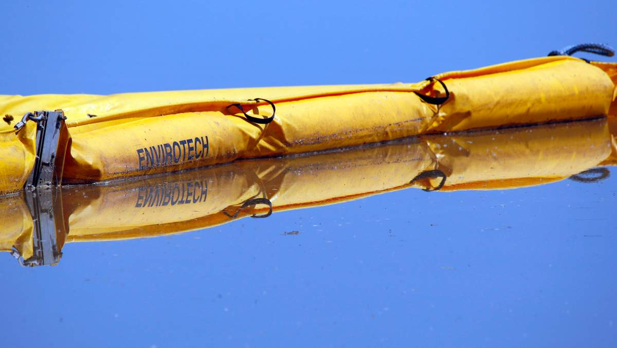 A boom stretches out to contain a pipeline leak on the Gleniffer reservoir near Innisfail, Alta., Tuesday, June 12, 2012. 
