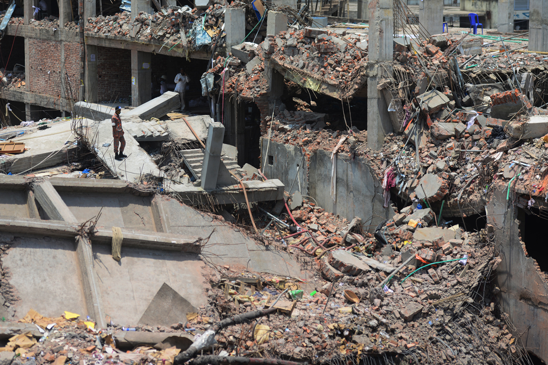 A Bangladeshi firefighter stands amid the debris as rescue and army personnel continue recovery operations after the eight-storey building collapsed in Savar, on the outskirts of Dhaka, on May 3, 2013. 