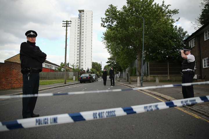Police at the scene in Woolwich following a major incident in which a man was killed, on May 22, 2013 in London, England. It has been reported that the government and police are treating the attack in Woolwich on a serving soldier as a possible terrorist attack. Police have confirmed that one man has died after being attacked in the street by two men and firearms and knives were involved in the incident.