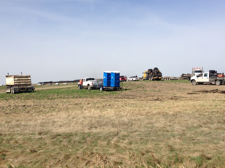 Dirt containment wall built when oil leaks after Saskatchewan train derailment.