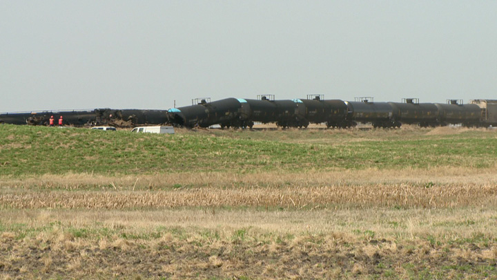 Dirt containment wall built when oil leaks after Saskatchewan train derailment.