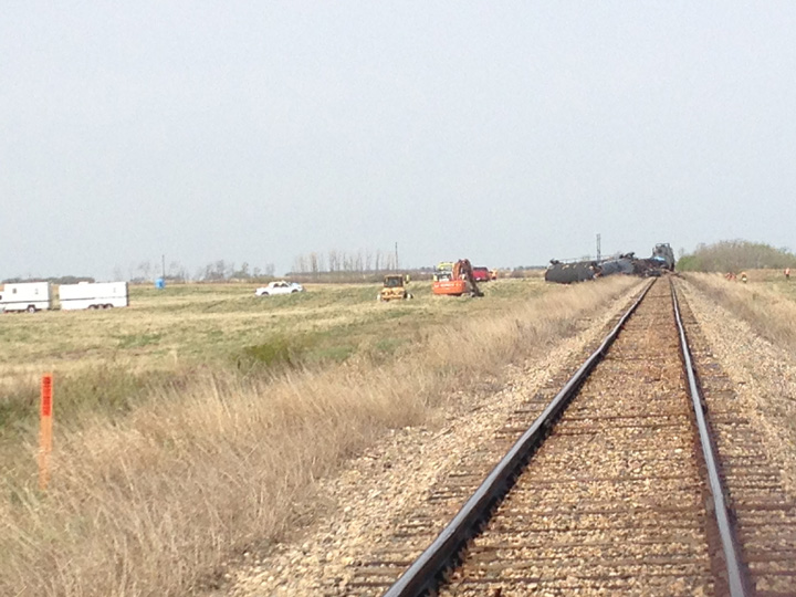 Dirt containment wall built when oil leaks after Saskatchewan train derailment.