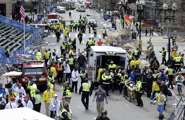 In this April 15, 2013 file photo, medical workers aid injured people at the finish line of the 2013 Boston Marathon following an explosion in Boston. 