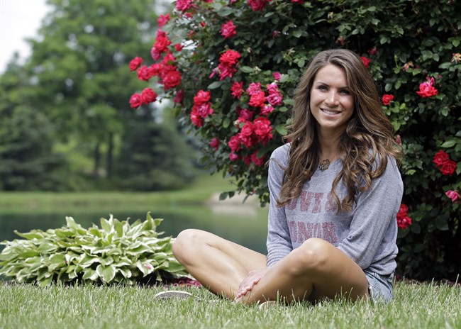 Mandi Grandjean sits outside her home in Canton, Ohio Wednesday, June 12, 2013. Grandjean, a recent graduate of Miami University in Ohio, says she's fine with the government doing secret surveillance of phone call records and Internet exchanges, but believes it's different when it comes to an employer, or even a coach. 