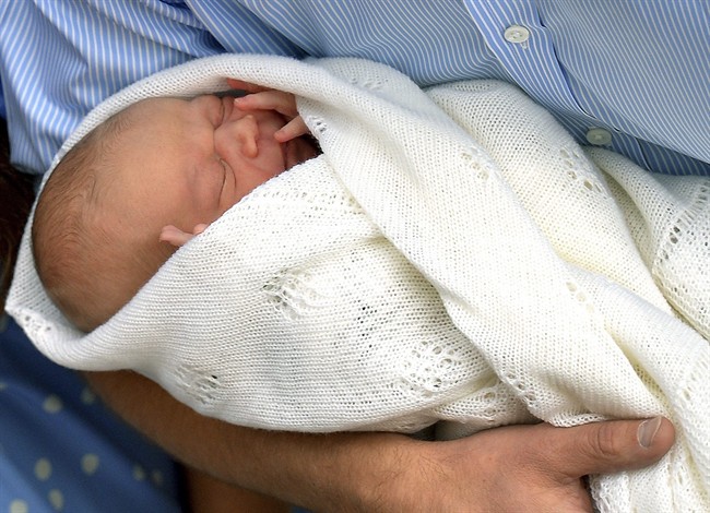 In this Tuesday, July 23, 2013 file photo, Britain\’s Prince William carries his new born son, the Prince of Cambridge into public view for the first time. outside the Lindo Wing of St. Mary\’s Hospital, in London.