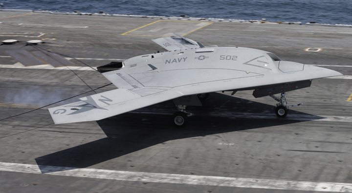 A X47-B navy drone grabs the wire as it lands aboard the nuclear aircraft carrier USS George H. W. Bush off the Coast of Virginia Wednesday, July 10, 2013. 