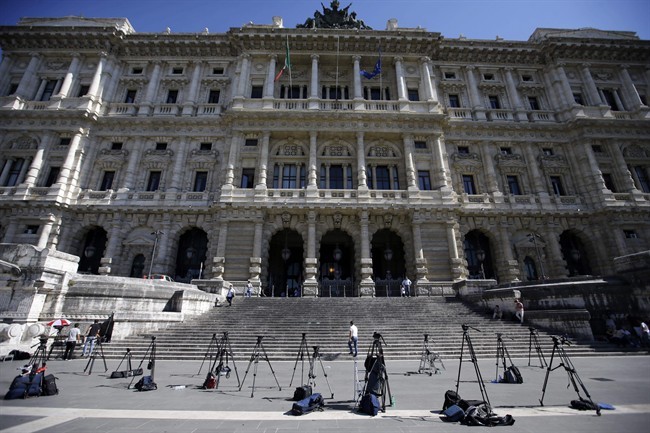 TV camera tripods stand outside the Court of Cassation building where Berlusconi's case on tax fraud will be decided, in Rome, Thursday, July 31, 2013.