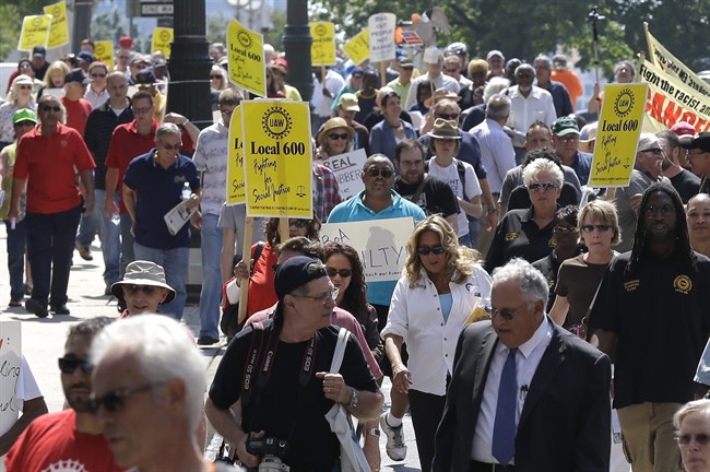 Protesters march in downtown Detroit Monday, Aug. 19, 2013.