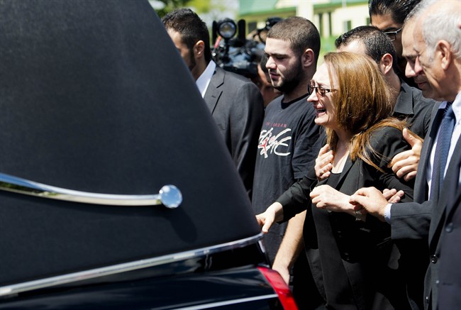 Sahar Bahadi (centre), mother of Sammy Yatim, cries as she follows the hearse carrying the casket of her son at his funeral in Toronto on Thursday, August 1, 2013. Yatim, 18, was shot and killed by Toronto police while on an empty streetcar last week. (Photo credit: The Canadian Press). Read the story here.