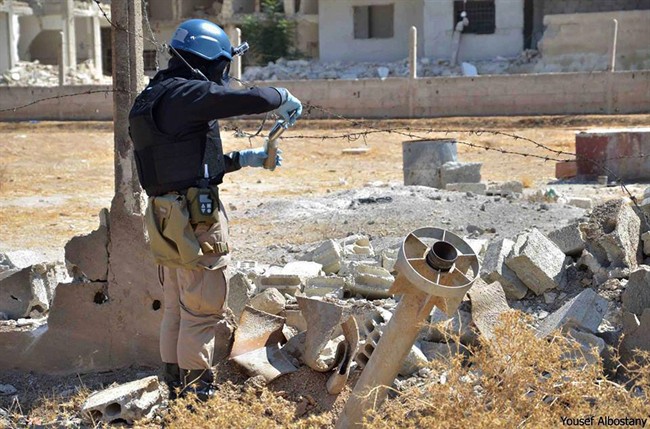 UN investigator takes sand samples near suspected chemical rocket, Ain Terma, Syria, Aug. 28, 2013.
