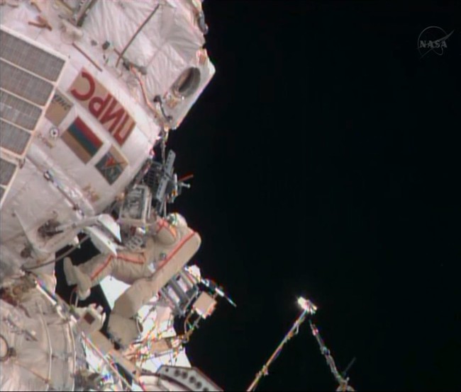Russian cosmonaut Fyodor Yurchikhin approaches a hatch on the International Space Station, about 7 hours into a spacewalk with Aleksandr Misurkin on Friday, Aug, 16, 2013. 