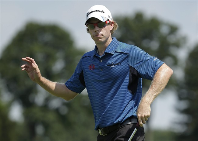 David Hearn, of Canada, reacts after making a birdie putt on the 16th hole during the first round of the PGA Championship golf tournament at Oak Hill Country Club, Thursday, Aug. 8, 2013, in Pittsford, N.Y. 