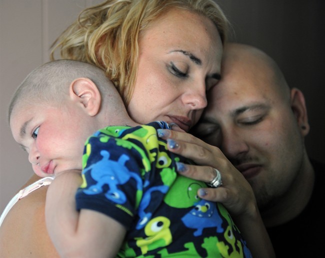 Christine Swidorsky holds her son, Logan Stevenson, 2, with her husband-to-be and Logan’s father Sean Stevenson, for a portrait on Tuesday, July 30, 2013 in their Jeannette, Pa., home. The Pennsylvania couple plans to have their dying toddler serve as the groom’s best man when they wed on Saturday, Aug. 3.  Read the full story here. 