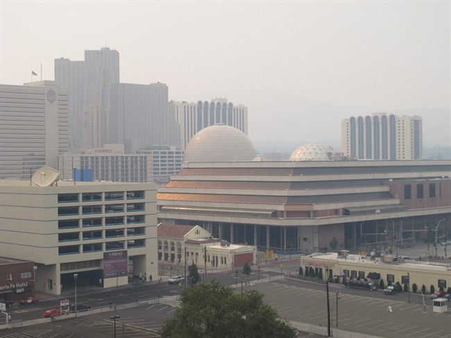 Hazy smoke from a wildfire more than 150 miles away near Yosemite National Park descended Thursday, Aug. 22, 2013, on Reno and the downtown casino district. Washoe County Health District officials issued an air quality alert because the Air Quality Index worsened to the unhealthy zone for sensitive groups, including the elderly and young children. 