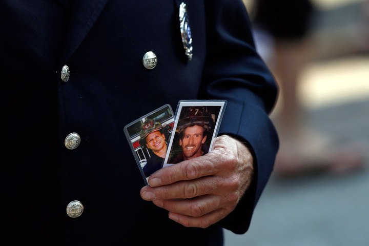 Friends and relatives of the victims of the 9/11 terrorist attacks gather at the National September 11 Memorial at the World Trade Center site, Wednesday, Sept. 11, 2013, for a ceremony marking the 12th anniversary of the attacks in New York. (Photo credit: AP Photo)