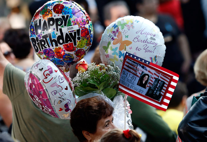 Friends and relatives of the victims of the 9/11 terrorist attacks gather at the National September 11 Memorial at the World Trade Center site, Wednesday, Sept. 11, 2013, for a ceremony marking the 12th anniversary of the attacks in New York. (Photo credit: AP Photo)