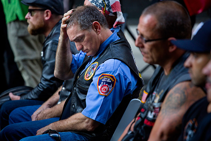 Retired FDNY Marshal Ernie Medaglia, of Bronxville, N.Y., who was at the attacks at the World Trade Center on Sept. 11, 2001, is emotional as he listens to New York Gov. Andrew Cuomo at a ceremony near the 9/11 Memorial honoring first responders and FDNY Rescue 1 on the 12th anniversary of the attacks on the World Trade Center in New York. (Photo credit: AP Photo)