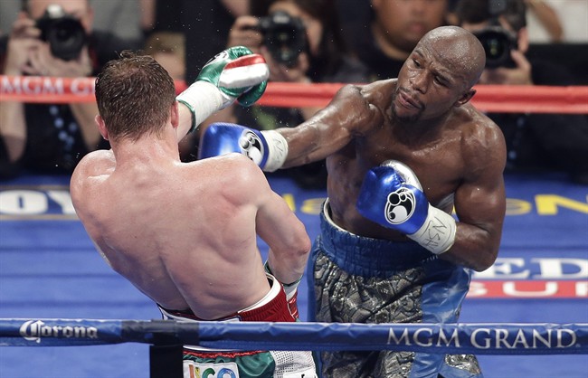 Floyd Mayweather Jr. throws a punch against Canelo Alvarez during a 152-pound title fight, Saturday, Sept. 14, 2013, in Las Vegas.