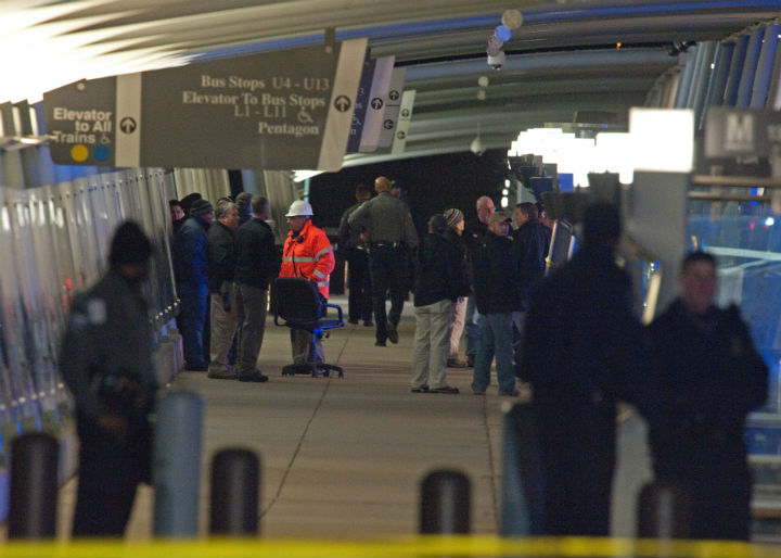 Law enforcement officials stand at a bus stop on February 4, 2010 in Washington, DC following a shooting at the Metro entrance to the Pentagon that left two police officers and a civilian suspect wounded and forced the US military headquarters to be put under security lockdown. The shooting erupted at 6:40 pm (2340 GMT) near the end of the evening rush-hour when an unidentified assailant opened fire, wounding the two Pentagon police officers, the Pentagon said. (Photo: Paul J. Richards/AFP/Getty Images)