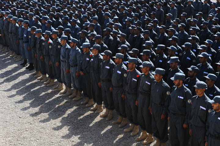 Members of the Afghan National Police (ANP) attend a graduation ceremony at a police training centre in Herat on October 10, 2013. Afghanistan forces, police and army, are due to take full security responsibility from their Western allies, a US-led NATO force, by the end of 2014. 