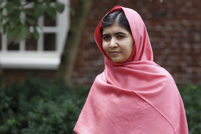 FILE - In this file photo taken Friday, Sept. 27, 2013, Malala Yousafzai listens as Harvard President Drew Gilpin Faust introduces her to reporters at Harvard University in Cambridge, Mass. 