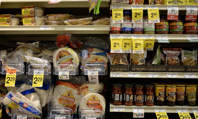 Tortillas and other items are seen in the International food aisle of a grocery store Wednesday, Oct. 16, 2013 in Washington. These days, tortillas outsell burger and hot dog buns; sales of tortilla chips trump potato chips; and tacos and burritos have become so ubiquitously “American,” most people don’t even consider them ethnic. (AP Photo/Alex Brandon)