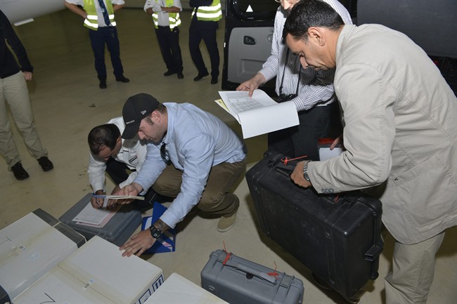 In this Saturday Aug. 31, 2013 file photo released by the Organization for the Prohibition of Chemical Weapons, samples brought back by the U.N. chemical weapons inspection team are checked in upon their arrival at The Hague, Netherlands. The Organization for the Prohibition of Chemical Weapons has won this year's Nobel Peace Prize, it was announced on Friday, Oct. 11, 2013. 