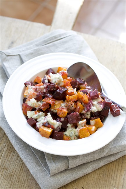 This Oct. 14, 2013 photo shows roasted squash and beets with creamed garlic in Concord, N.H. To soften its flavor, the garlic is cooked in a long, slow simmer in heavy cream, then pureed.