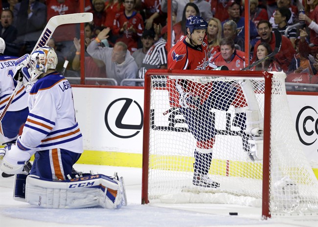 Washington Capitals center Brooks Laich (21) celebrates his goal pat Edmonton Oilers goalie Jason LaBarbera (1) in the first period of an NHL hockey game, Monday, Oct. 14, 2013, in Washington . 