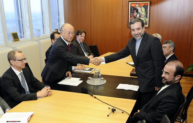 Iran's deputy Foreign Minister Abbas Araghchi, right, and Director General of the International Atomic Energy Agency, IAEA, Yukiya Amano shake hands next to IAEA deputy director general Tero Tapio Varjoranta, left, and Iran's Ambassador to the International Atomic Energy Agency, IAEA, Reza Najafi, right, prior a meeting at the International Center in Vienna, Austria on Monday, Oct. 28, 2013. 