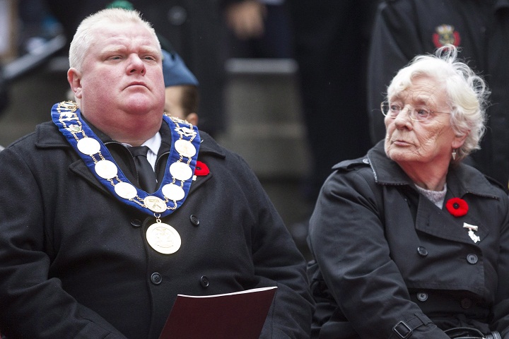 Margaret Delmore (left), the ceremonial Memorial Cross Mother, sits next to Toronto Mayor Rob Ford at the cenotaph during the Remembrance Day service in Toronto on Monday, November 11, 2013. (The Canadian Press/Chris Young)