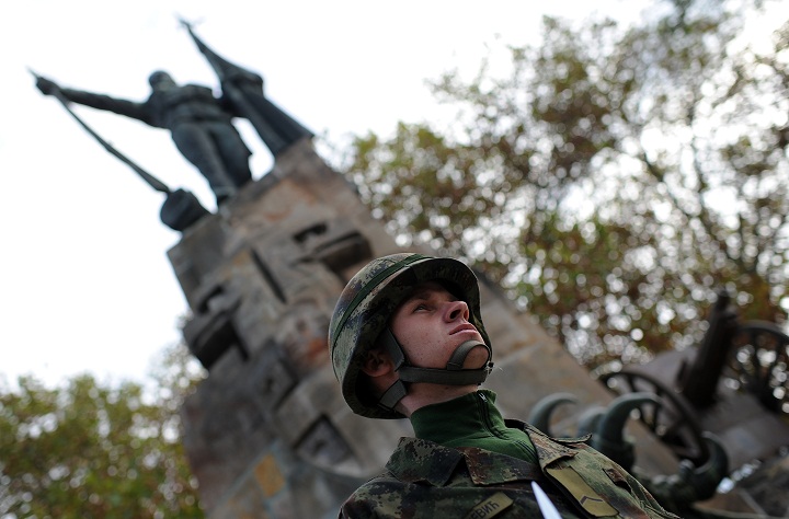 A Serbian Army soldier stands at attention in front of a monument on November 11, 2013 during a Remembrance Day ceremony, marking the 99th anniversary of the end of World War I at the French Soldiers Cemetery in Belgrade. (Andrej Isakovic/Getty Images