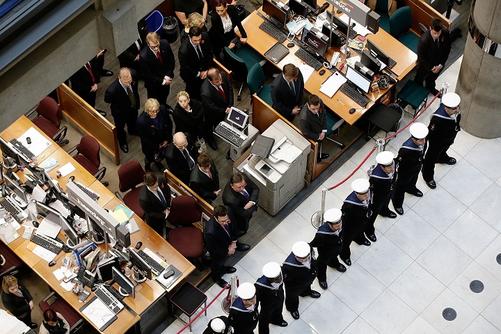 Members of the Royal Navy form an honour guard as brokers and underwriters line the balconies and escalators of the Lloyd’s of London building during a service on November 11, 2013 in London, England. The annual Armistice Day service honours those who have lost their lives during times of war. The service at Lloyd’s is observed with the ringing of the Lutine Bell, the laying of wreaths before the Book of Remembrance and a two minute silence. (Matthew Lloyd/Getty Images)