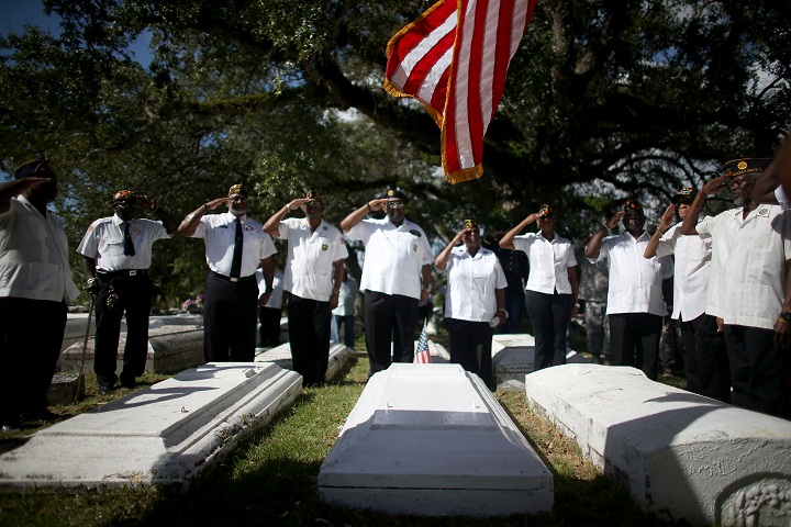 Military veterans salute during a Veterans Day ceremony held in the Grove Bahamian Cemetery on November 11, 2013 in Coconut Grove, Florida. (Joe Raedle/Getty Images)