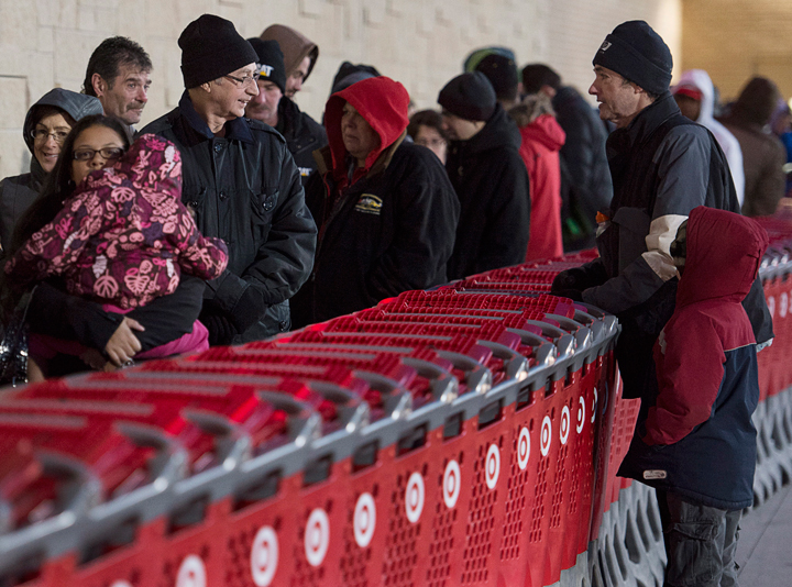 Shoppers wait in line at the Target store in Dartmouth, N.S. on Friday, Nov. 29, 2013. Black Friday, the most important shopping day of the year in the United States, is having an impact on Canadian sales as retailers work to keep consumers home, north of the border. (Photo credit: Andrew Vaughan/The Canadian Press)