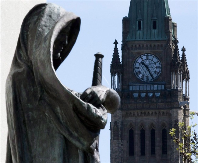 "Truth", left, the statue at the entrance of the Supreme Court of Canada in Ottawa, is shown on May 7, 2010. 